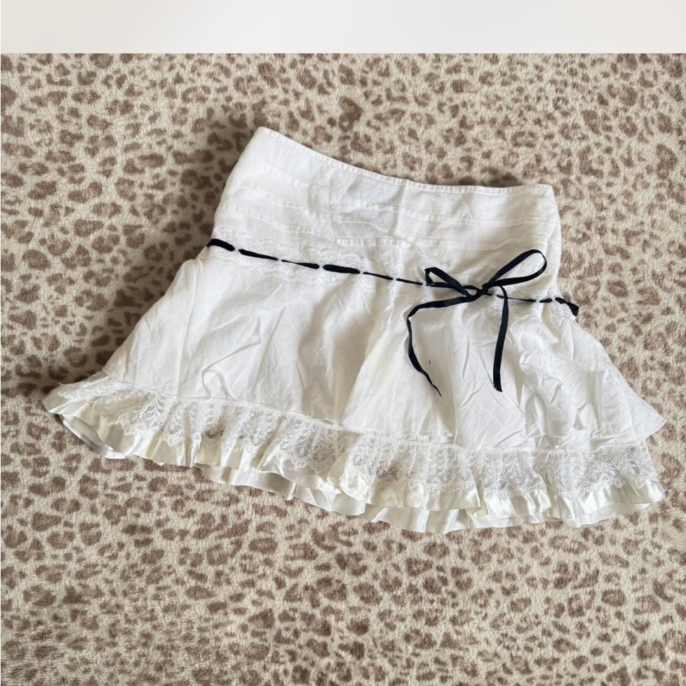 white mini skirt with lace and black ribbon bow